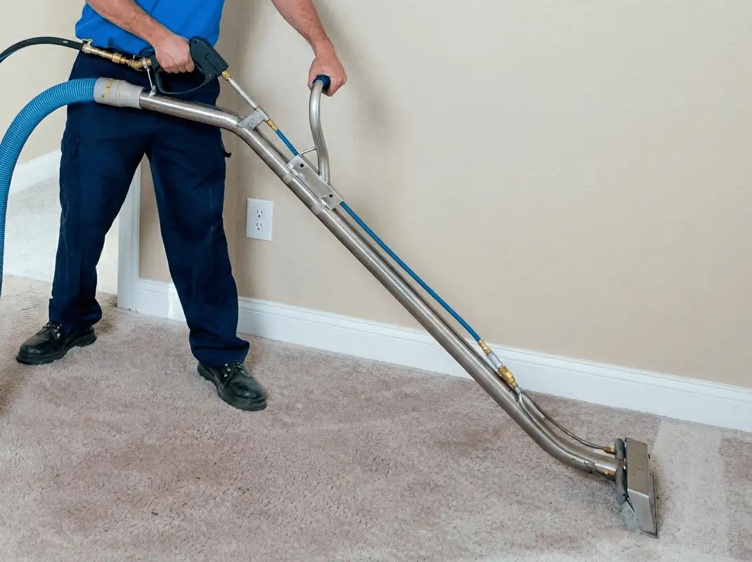Professional operating a liquid removal machine on a carpeted floor in San Diego, CA